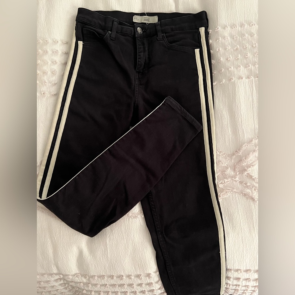 Black jeans with white stripe